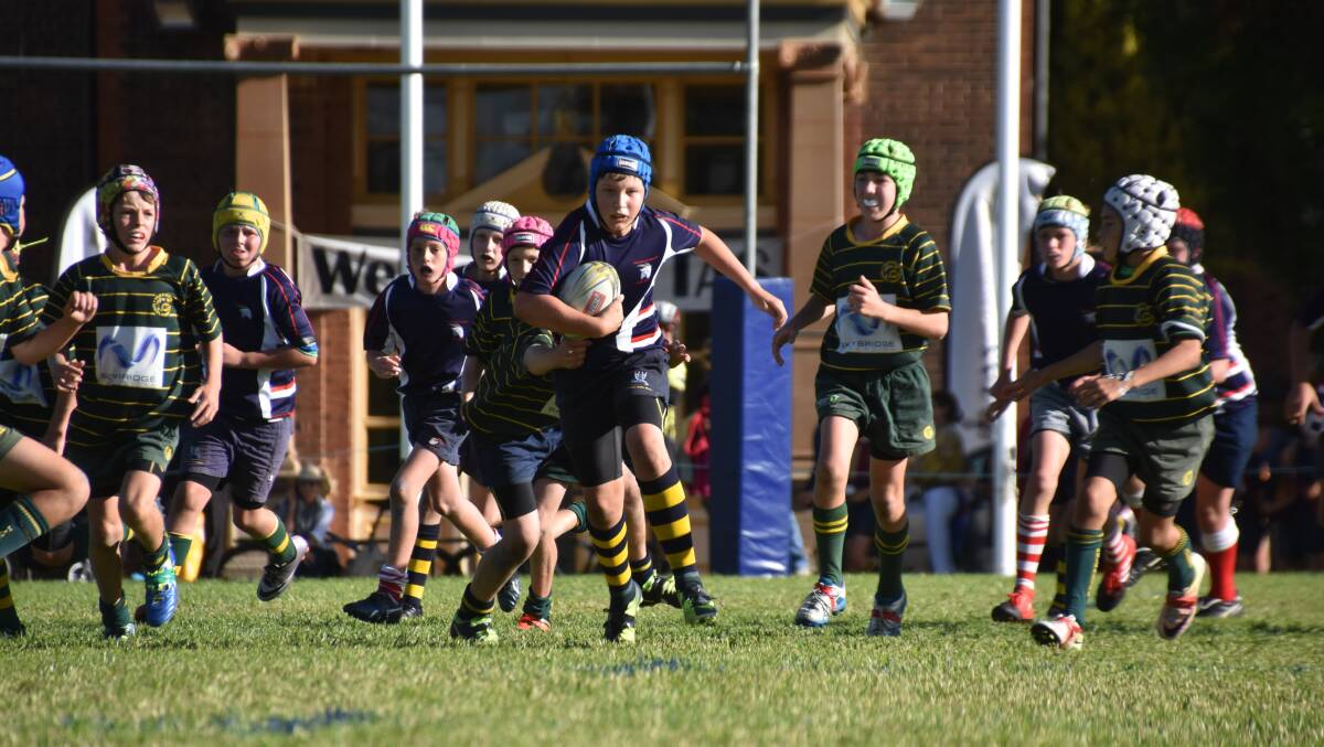 IN THE CLEAR: Tom Finlayson breaks through for the Highland Goats at the TAS rugby carnival on the weekend.