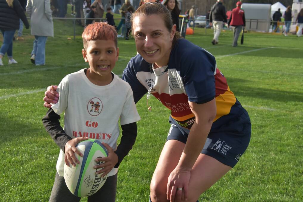 One of the New England Rugby Union grand final ball boys was excited to have his picture taken with New England Referee of the Year Rachel Horton. Picture by Ellen Dunger