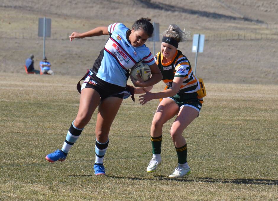 GALLANT EFFORT: Spudettes player Tamarla Smith is tagged by Walcha's Shae Partridge in the league tag game on Saturday. 