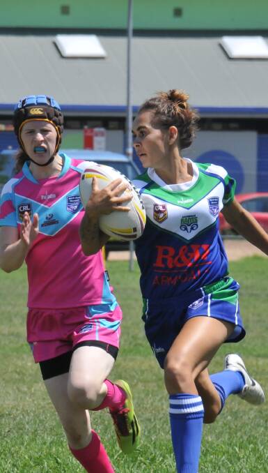 BREAKOUT COMPETITION: Anarla Moran streaks away from defenders in the opening round of the North West women's rugby league nines competition. 