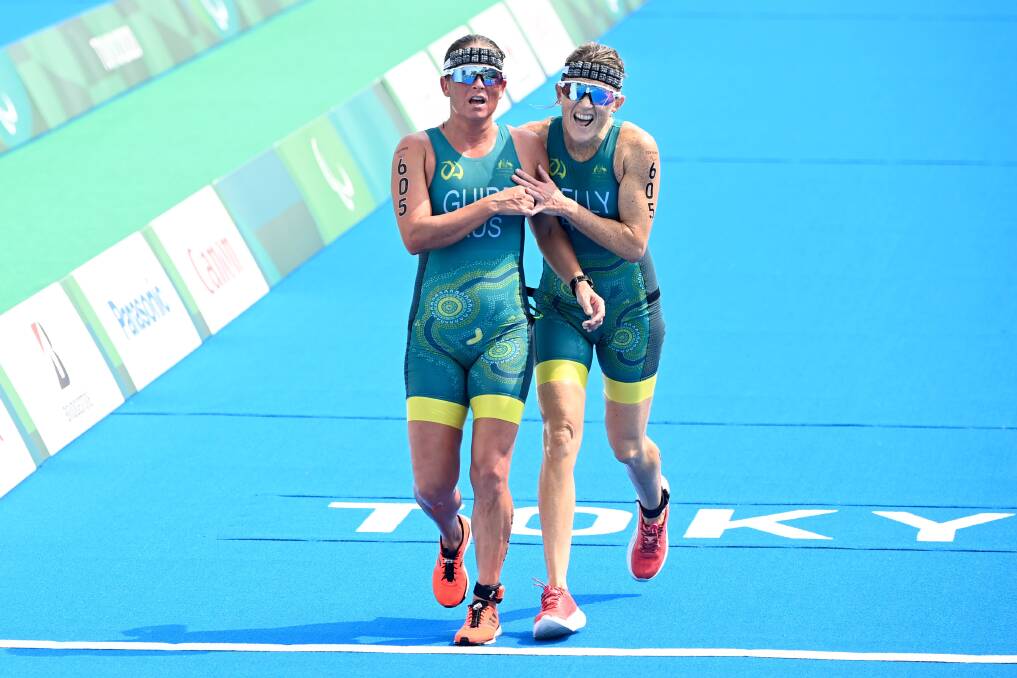 FIGHTING FINISH: Guide Brie Silk and Katie Kelly finish the triathlon in Tokyo. Photo: Paralympics Australia. 