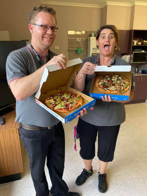 LUNCH SORTED: Aged care workers at Ken Thompson Lodge were thrilled when a load of pizzas was donated and delivered. Photo: Supplied. 