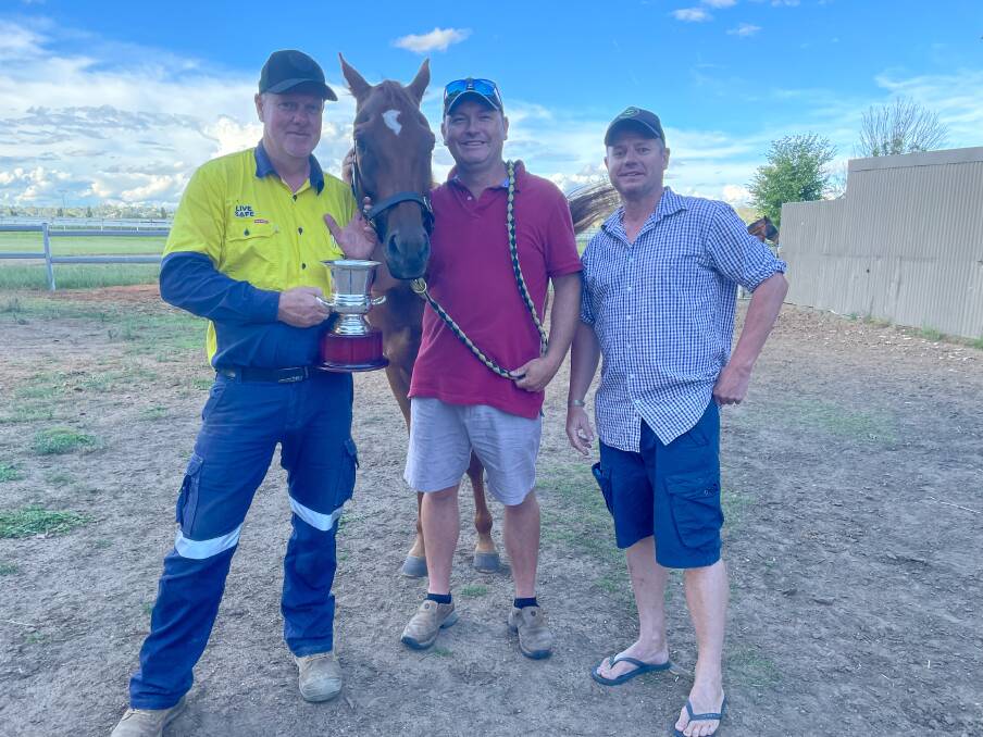 Some of One of the Kind's owners Richard Montgomery, trainer Mitch Faulkner and Robbie Davis with the Deepwater Cup and its 2022 winner. 