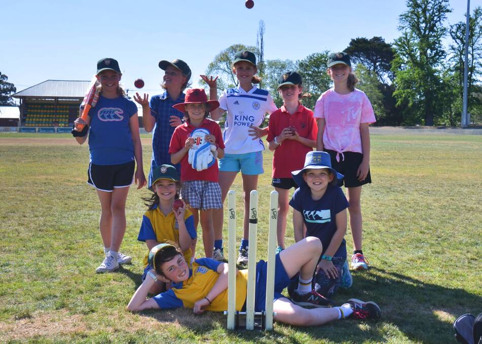 The under-10 girls' Hillgrove team are having a blast playing cricket, and doing lots of handstands. 