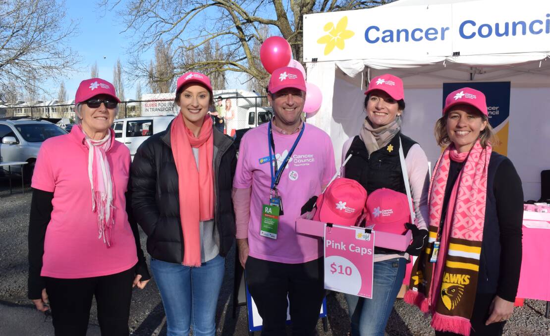 PINK POWER: Lyn Deviries, Ella DiGuglielmo, Brock Kerslake, Sharon King and Bec Townsend are out and about selling Cancer Council Tasmania merchandise as part of the Hawthorn Pink Ribbon Game. Picture:Tess Brunton