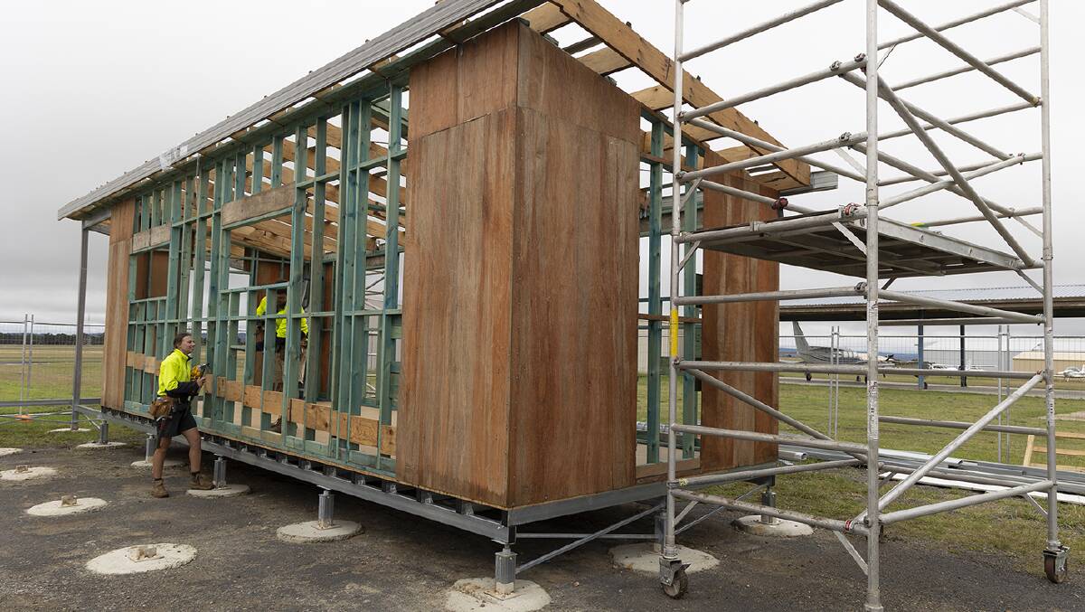 Carpenters work on the timber frames for the construction of the airside amenities block at the Armidale Regional Airport.