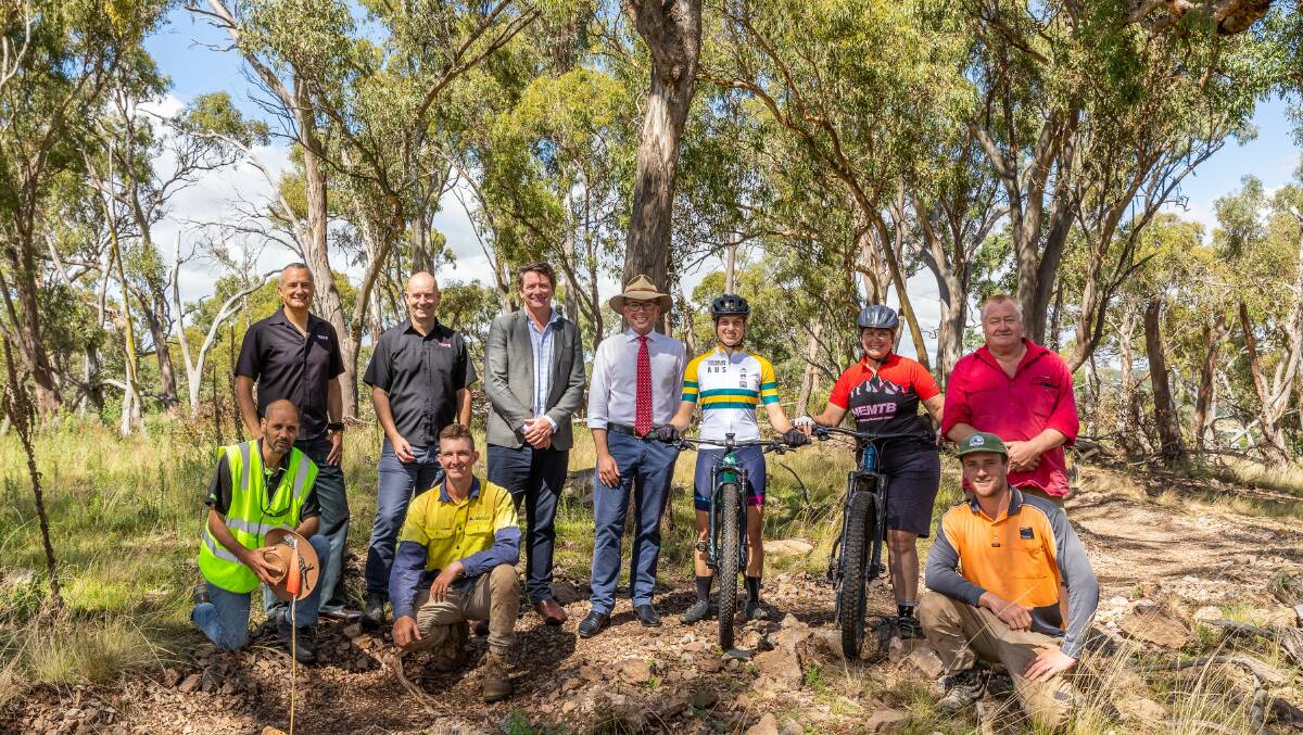 New England Mountain Bikers Vice President Peter Hosking, President James Harris, University of New England Life Director David Schmude, Northern Tablelands MP Adam Marshall, mountain bikers Katherine Hosking and June Billings and Armidale Regional Councillor Jon Galletly. Front, University of New England Cultural Officer Steve Ahoy, left, and Dirt Arts Tobias Kerr and Darcy Coutts.