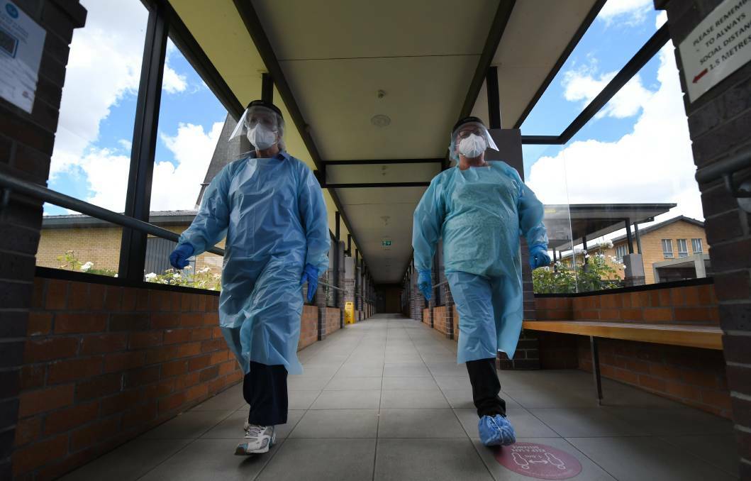 Employees at local aged care homes wore full protective gear during a lock down earlier this year. Picture by Gareth Gardner