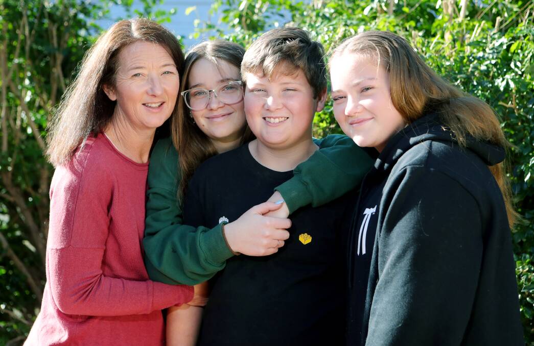 Tim, pictured with mum Trish and sisters Caitlyn and Chloe, returns to his backyard on Wednesday. Pictures: Sylvia Liber 