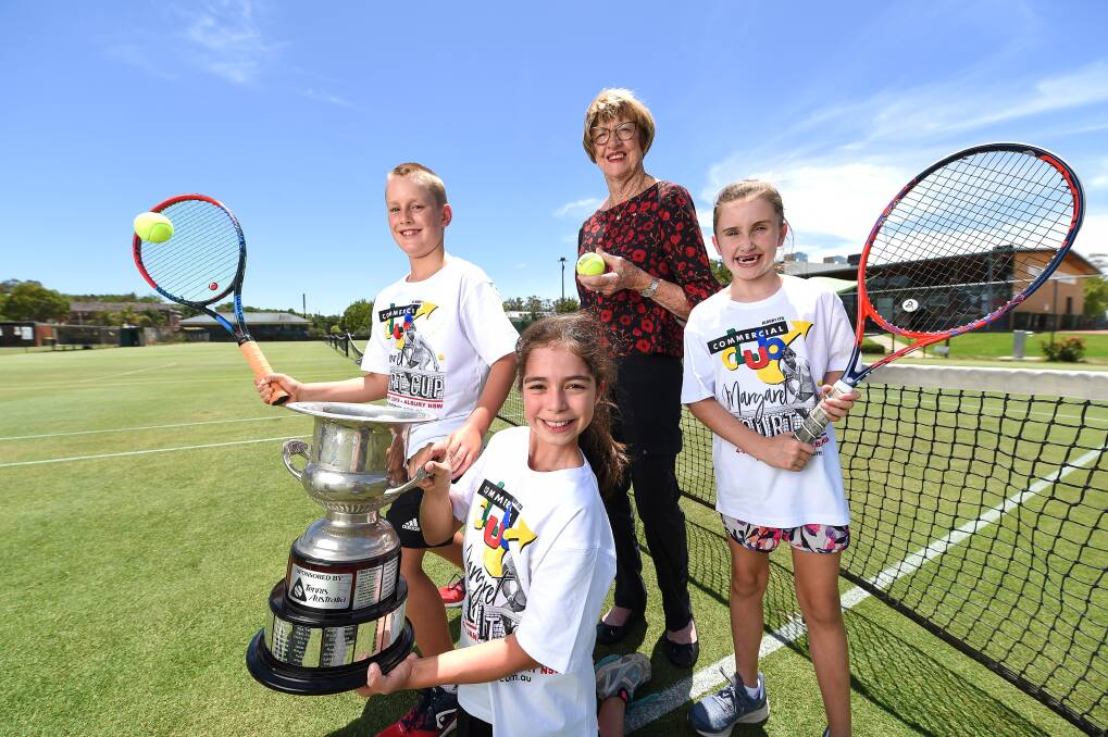 ALL SMILES: Margaret Court is welcomed back to the Albury grass courts by young guns Billy Hilton, 10, Sofia Oliver, 10 and Lara Meagher, nine, ahead of the 2019 Margaret Court Cup. Picture: MARK JESSER