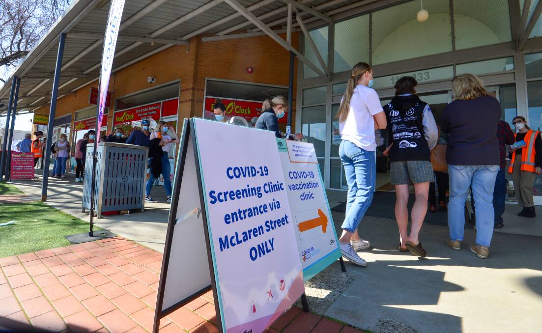 VACCINE ROLLOUT: People line up at Bendigo's coronavirus vaccination clinic in Mollison Street on Wednesday. Picture: DARREN HOWE