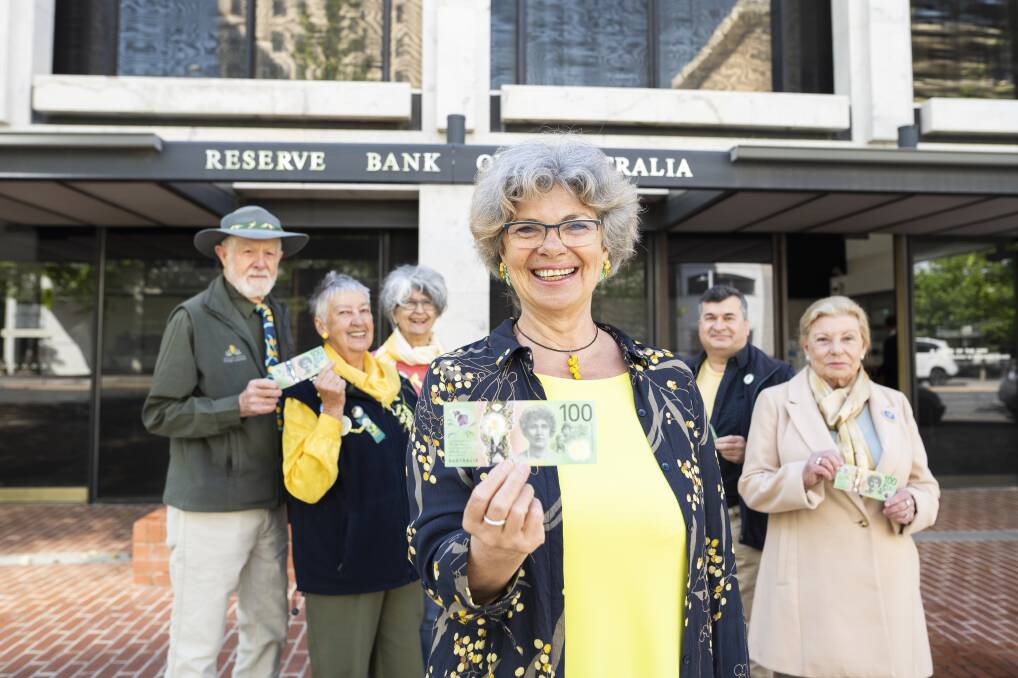 Wattle Day Association members Warwick Wright, Pat Wright, Chris Alexion, Suzette Searle, Dr Phillip Kodela, and Dawn Searle outside the Reserve Bank in Canberra on Thursday with the new $100 wattle note. Picture: Dion Georgopoulos 