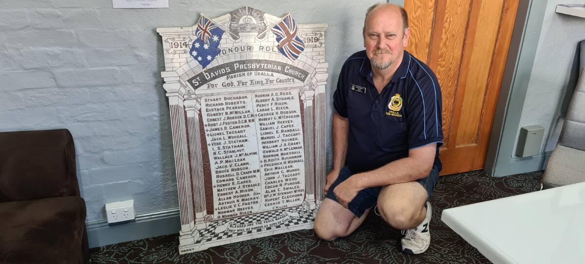 BACK HOME: Uralla RSL sub-branch president Russ French with the honour roll. 