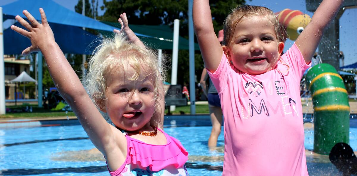 FUN IN THE SUN: Makenzie Burton and Georgia Brodbeck cooled down during the heatwave that hit Armidale this week at Monckton pool.