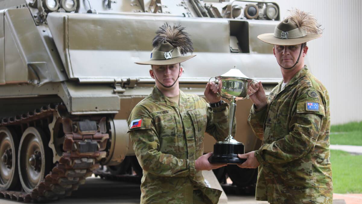 PIECE OF HISTORY: Army Reserves soldier and marksman Alex Reeves and Major Grant Prendergast hold the Saumarez Cup that was recently found in Tamworth. Photo: Madeline Link.