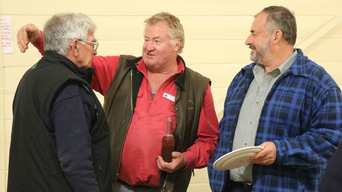DOWN TO BUSINESS: Councillor Jon Galletly (centre) chats to Wollomombi residents.