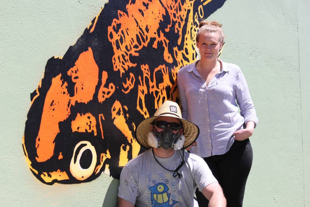 URBAN ART: Artist Crisp with Goldfish Bowl manager Bonnie Erskine-Smith at the new mural on the corner of Jesse and Rusden Street.