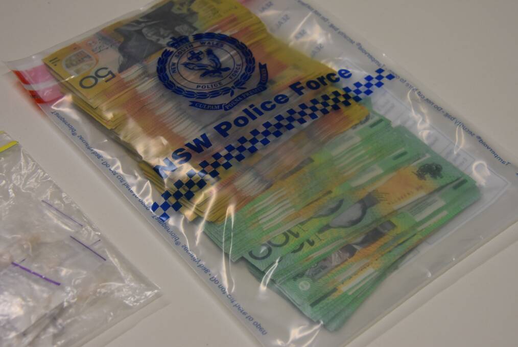 STRIKE FORCE JANIAN: Cash seized as part of a police sting to bust an alleged major drug ring in Armidale. Photo: Nicholas Fuller