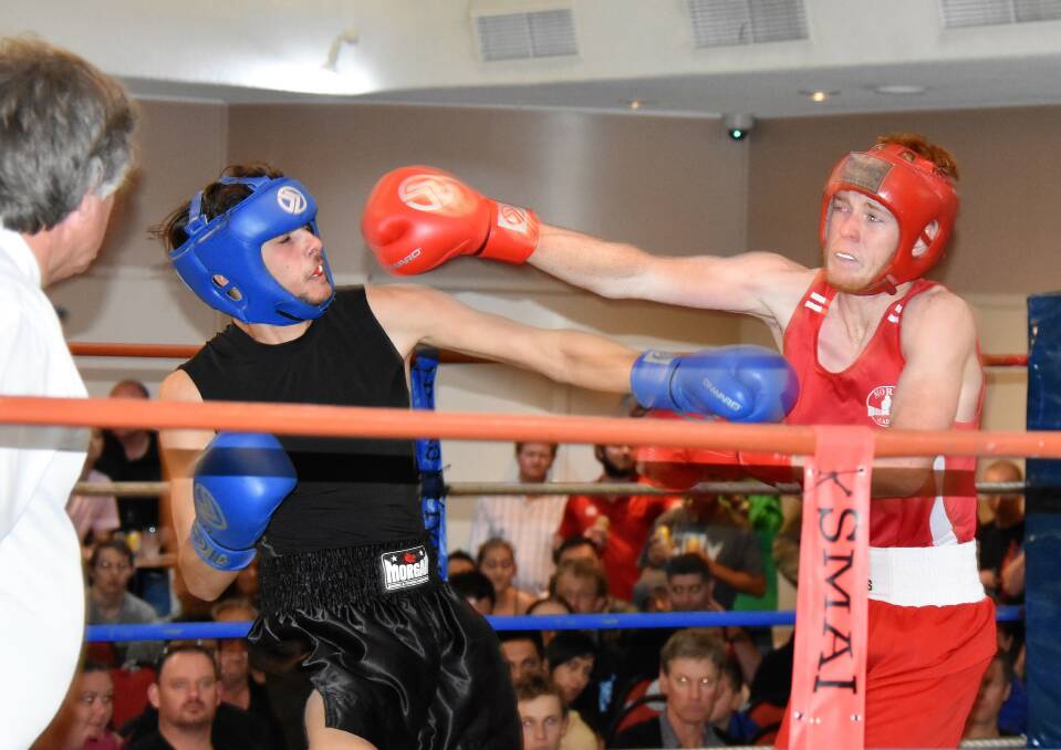 Pack a punch: Moree Boxing Academy's Cody Moore (red) won the North West Welterweight title by a unanimous points decision in the main fight of the night. 