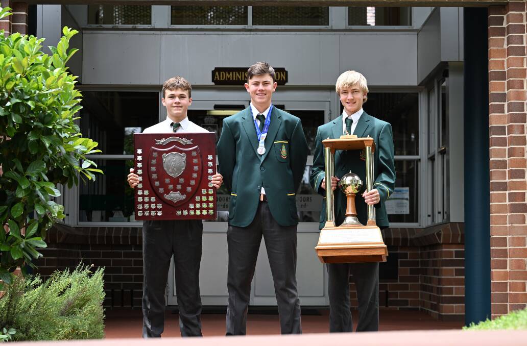 Darcy Hannaford (rugby union), Charlie Stone (cricket) and Jack Marshall (hockey) with the spoils of Farrer's title trifecta. Picture by Gareth Gardner