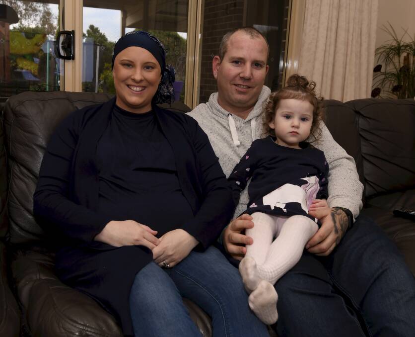 FIGHTING: Renee, Trevor and Eden Jones relax at home between Renee's chemotherapy treatments. Picture: Lachlan Bence