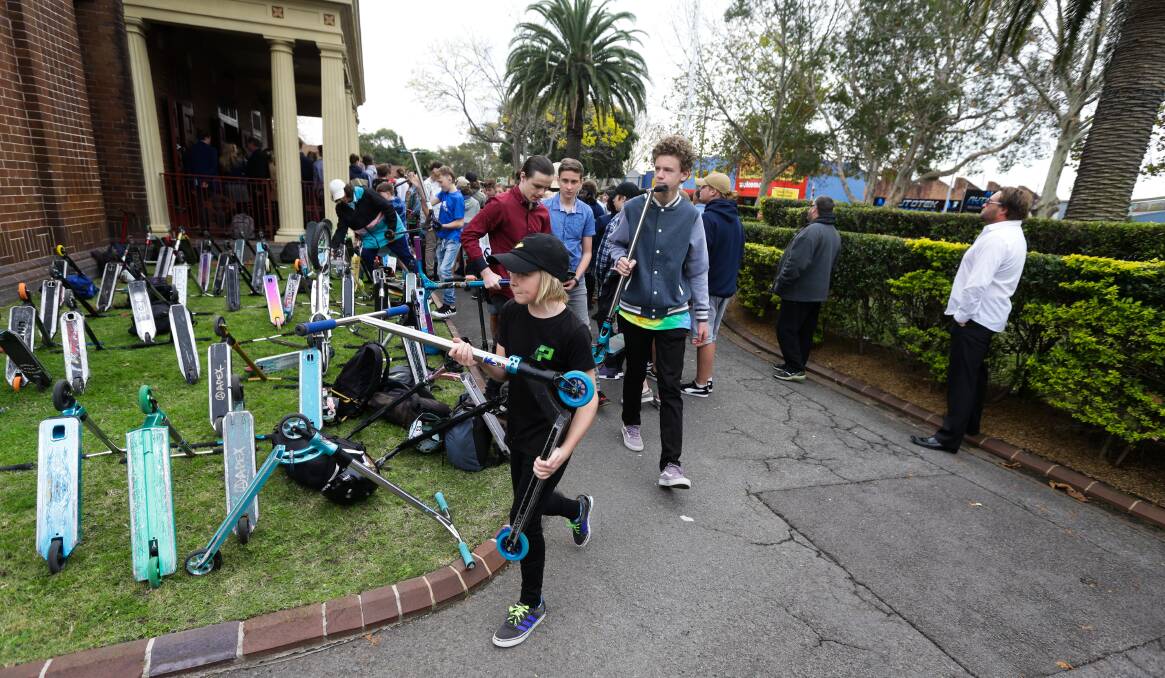 Mourners left scooters upturned on the cathedral lawn in memory of the promising skater. Photo: Jonathan Carroll