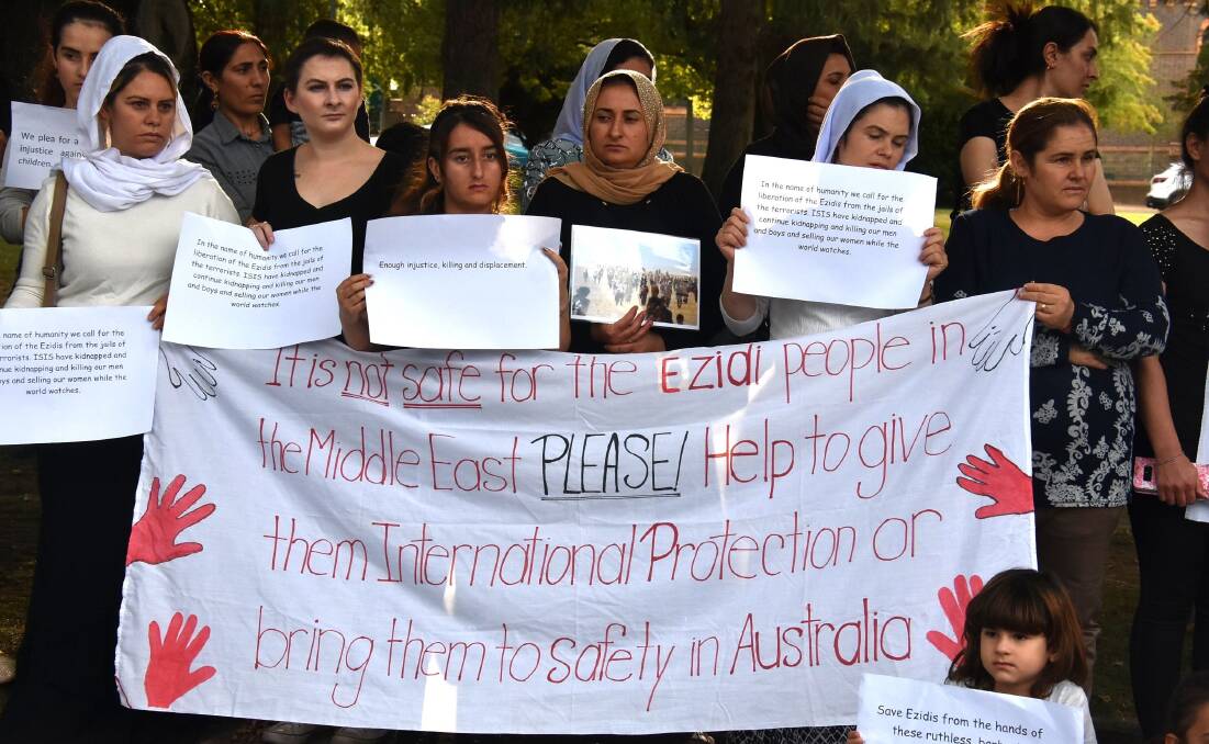 RALLY: Ezidi women and their Armidale friends mourn for the 50 women found murdered last month. Photo: Nicholas Fuller