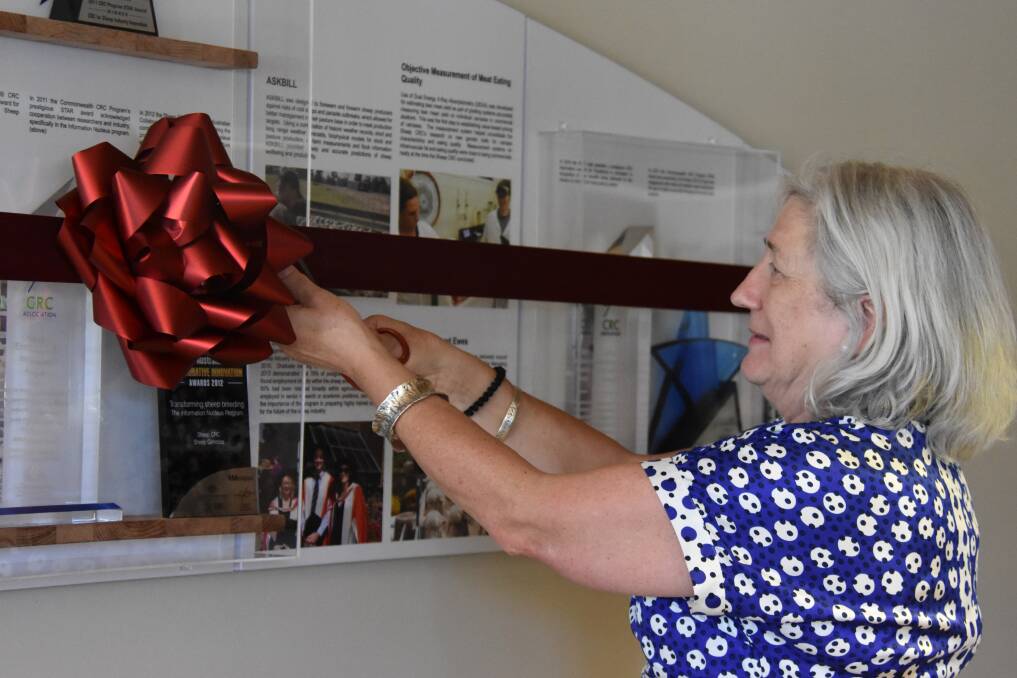 Professor Heywood cuts the ribbon on the legacy wall. Photo - Nicholas Fuller