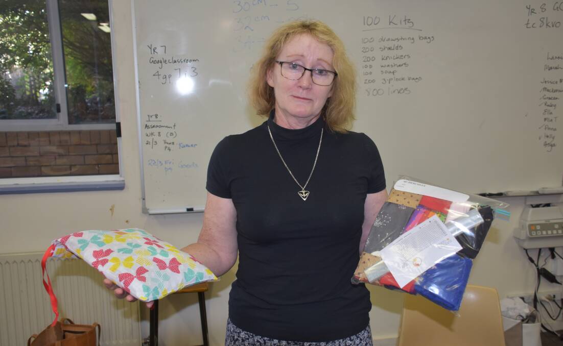 TRAVEL: Inverell member Bev Walls showing one of the kits she will take to PNG. Photo: Nicholas Fuller