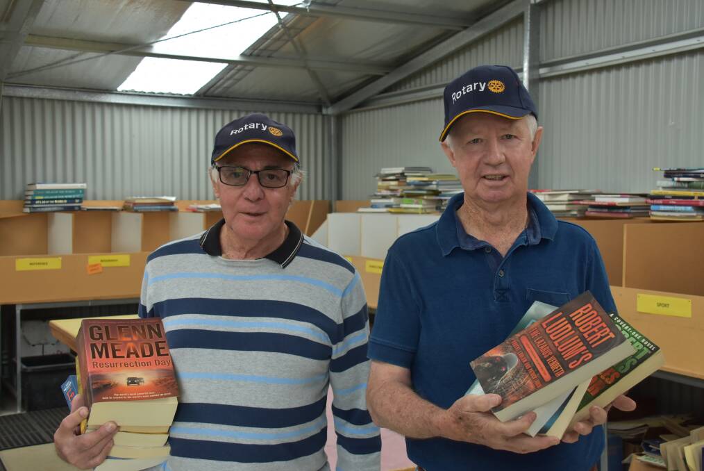 BOOKED IN: Rotary Central members Lindsay Kaynes and Ian Garske sorting through some of the books donated. Photo: Nicholas Fuller