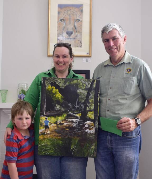 PEOPLE'S CHOICE: Guyra artist Danae Batt receives an award from Guyra Lions Club president Graeme Shiels for her painting. Her son Cameron was the subject of the picture. Photo supplied.