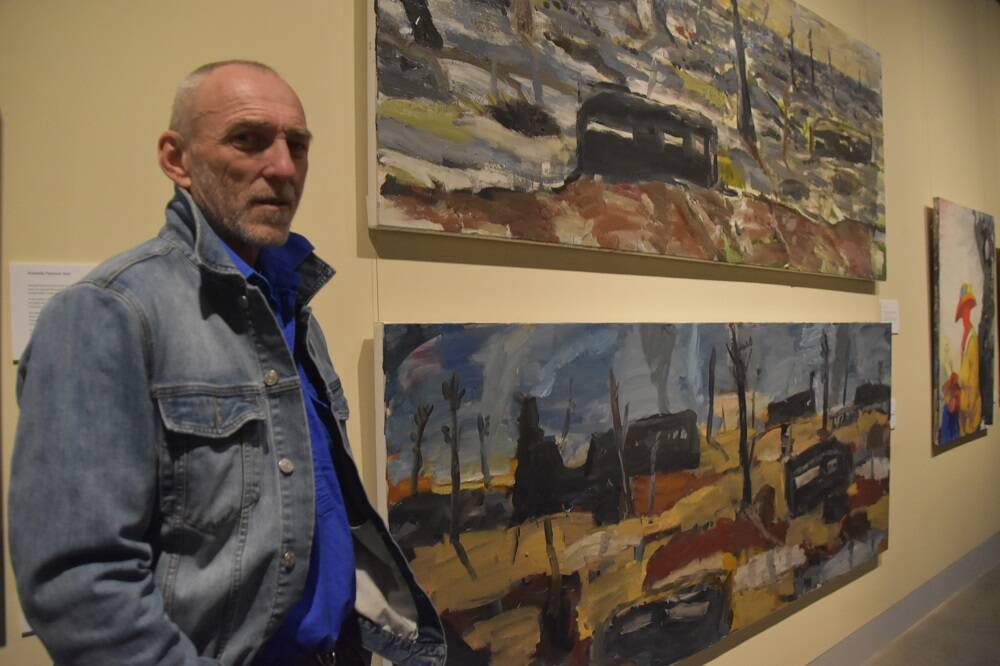 LANDSCAPE PAINTER: Ross Laurie with his war paintings.  Photo: Supplied.