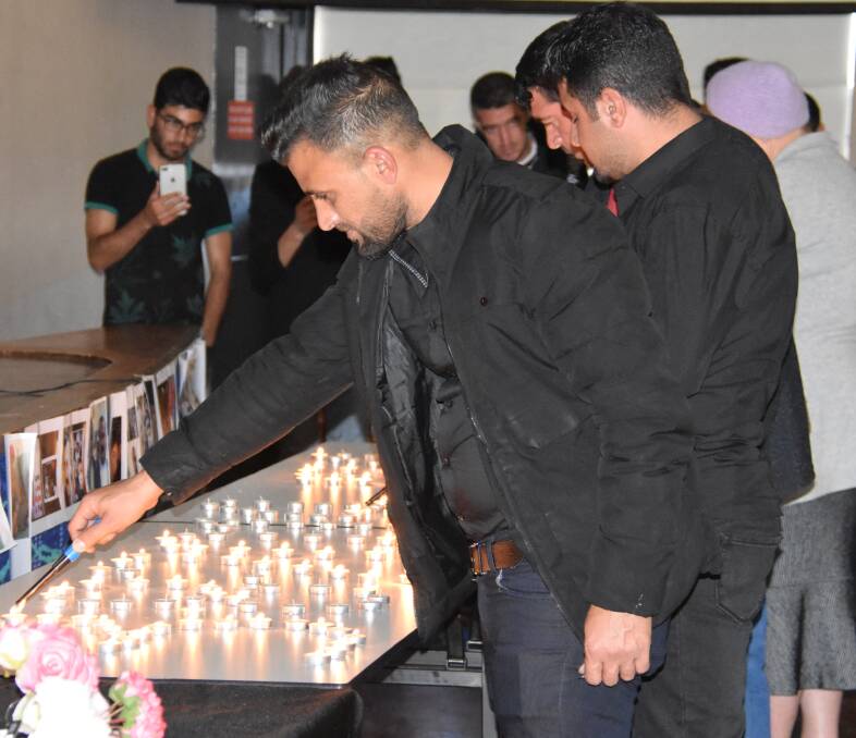 REMEMBRANCE: Lighting candles for the memory of the Ezidis massacred in Sinjar (Shingal) five years ago. Photo: Nicholas Fuller