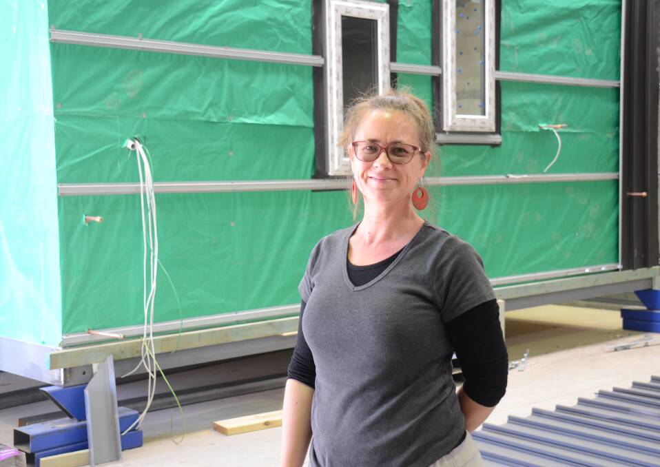 INNOVATOR: Armidale artist and designer Kylie Mitchell working on the prototype pod house. Photo: Nicholas Fuller