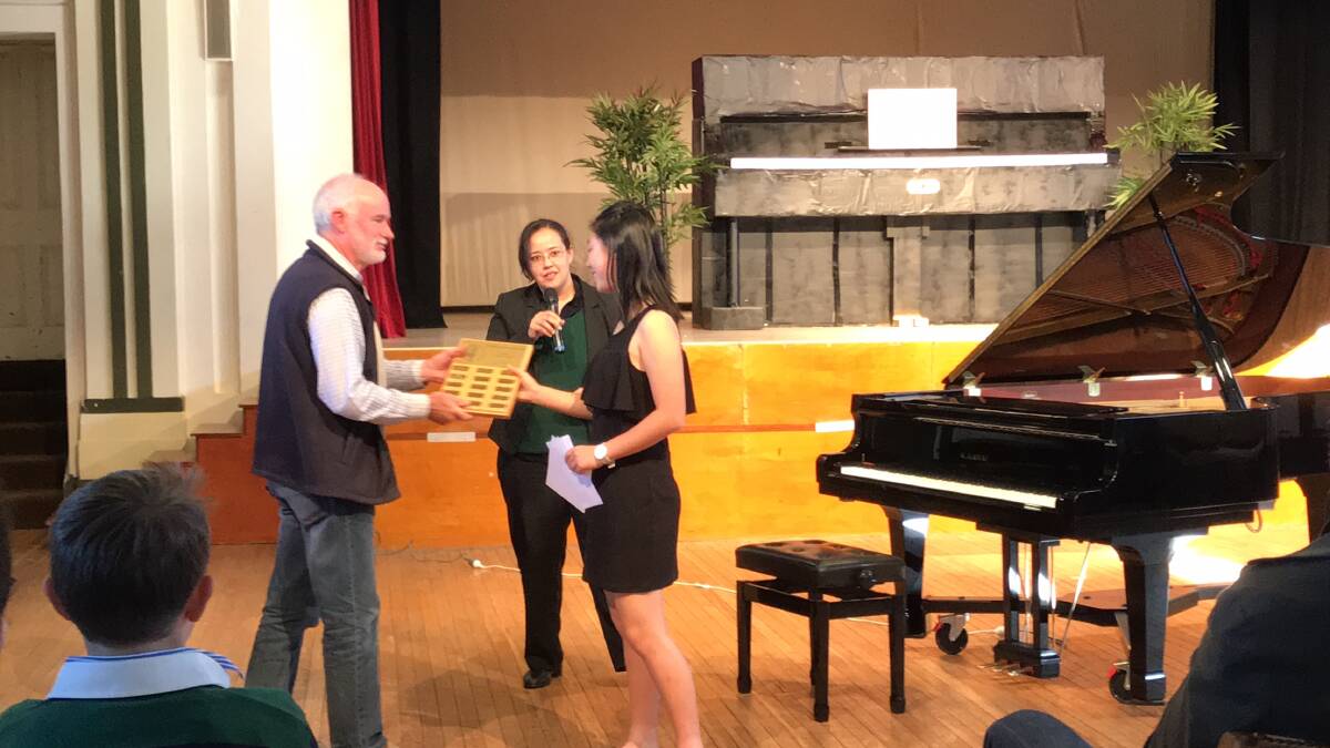 PIANIST: John Hadfield presenting the Armidale & New England Piano Tuning Perpetual Shield to Xinyue Li, winner of the New England Piano Age Championship (16-18 years)
