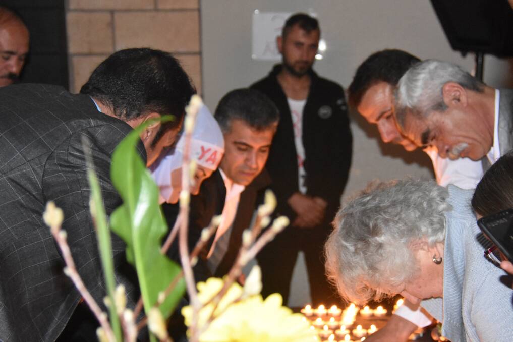 REMEMBRANCE: Yazidis and their Australian friends light candles to mark the fourth anniversary of the Sinjar massacre. Photo: Nicholas Fuller