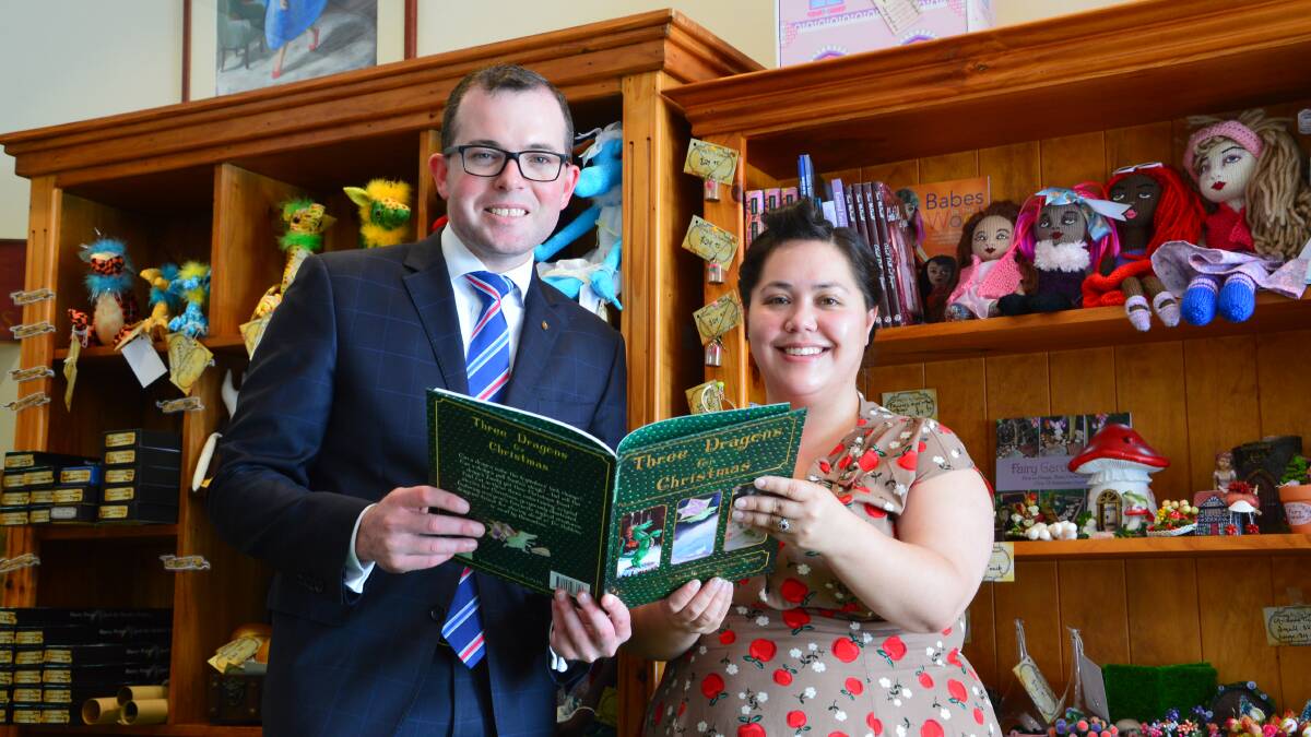 BOOK IN!: Northern Tablelands MP Adam Marshall and Armidale author and event organiser Beattie Alvarez read a locally produced book.  Photo: Supplied.