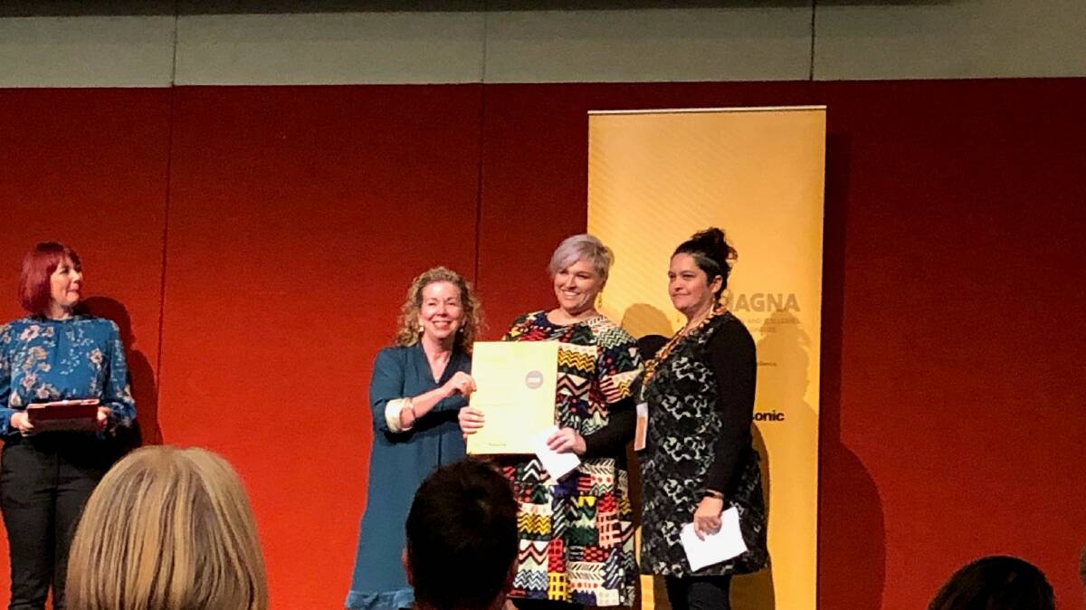 REMEMBERING: NERAM director Rachael Parsons and curator Bianca Beetson accepting the award for the Myall Creek and Beyond programme. Photo supplied.