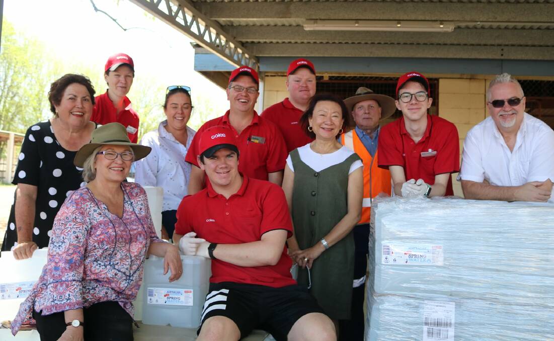 WORKING TOGETHER FOR THE COMMUNITY: CWA, council staff, and Coles at the Guyra Showgrounds. Leonie Hawkins at left; Jessica Watters, Andrew Harris. Aileen MacDonald front left, Susan Law front centre. Picture by Diane Gray.