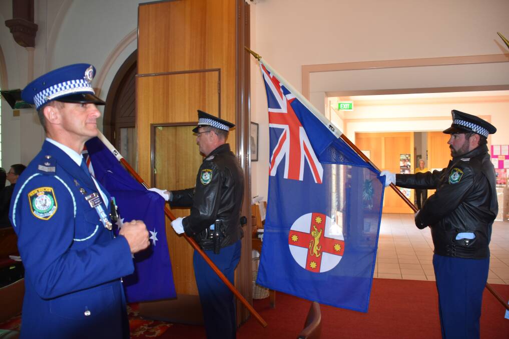DAY OF HONOUR: Detective Sergeant Mark Garvey, New England Police District protocol officer, with flag bearers Sergeant Stuart Gray and Senior Constable James McClenaghan. Photo: Nicholas Fuller