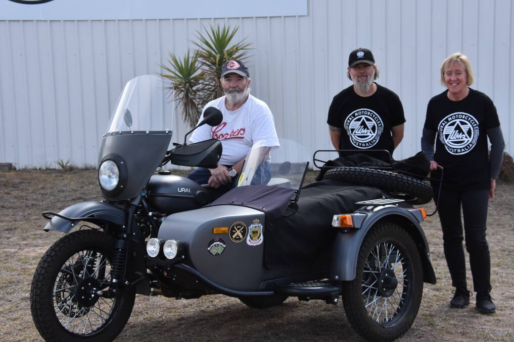 FROM RUSSIA...: Chris Barnden, Mathew Hodge, and Clare Mailler, from Ural Australia, with a Ural Motorcycle. Photo: Nicholas Fuller