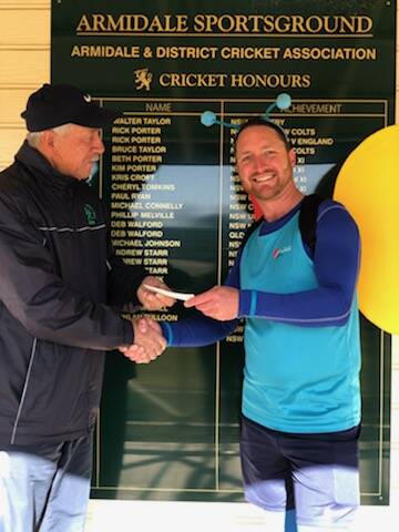 GOOD CAUSE: Mike Porter (Armidale District Cricket Association) presents the $3500 cheque to Gabriel Leroy, running for Beyond Blue in this weekend's City2Surf in Sydney. Photo supplied.