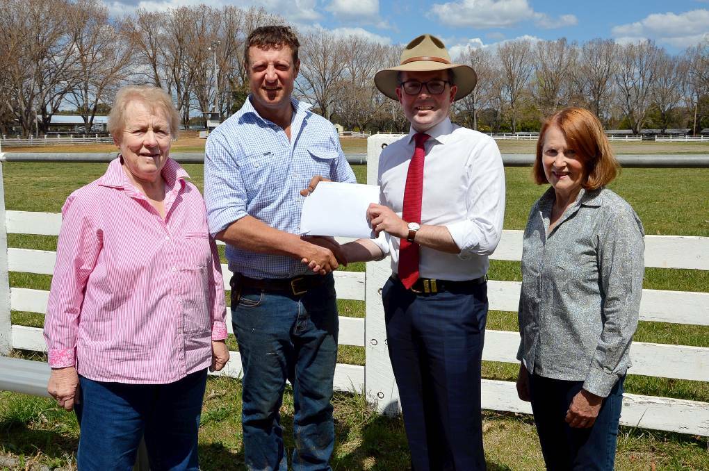 SHOWING THE MONEY: Northern Tablelands MP Adam Marshall presenting Guyra Show Society president Richard Post with a $5,000 cheque for next year’s show. They are flanked by Show Society Secretary Dorothy Lockyer (left) and Vice President Rita Williams (right). Photo: Supplied