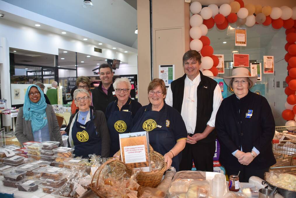 WORKING TOGETHER: CWA members Taj Mari, Emmy Forge, Bev Eichorn, Thea Zwiebel, and Eileen Mitchell, with Coles Armidale's store manager Nick Ridley and store support manager Kyle Swift. Photo: Nicholas Fuller