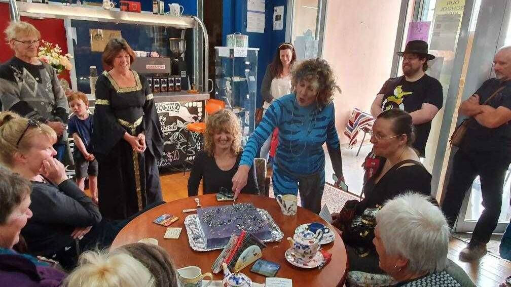 DIVIDING THE COSMOS: Debra O'Brien cuts the cake. Photo: Richard Sheridan.