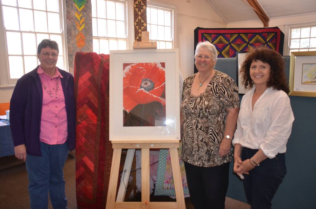 TALENTED LOCALS: Quilt and Craft Display organiser Robin Godlonton, TroutFest co-ordinator Lynne Chapman, and Guyra artist Kay Smith. Photo: Nicholas Fuller