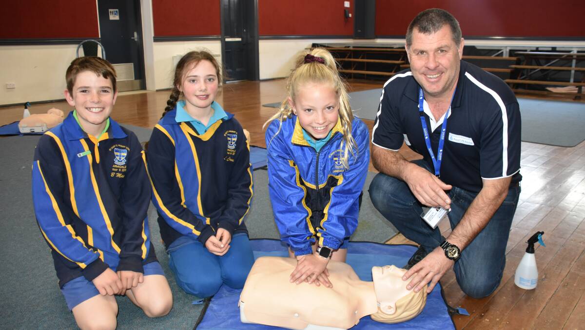 LIFE-SAVING LESSONS: Bernard May, Lucinda Crosby, and Isabella McKay, Year 6 students at St Mary's Catholic Primary School, Armidale, learn CPR from Cameron McFarlane. Photo: Nicholas Fuller