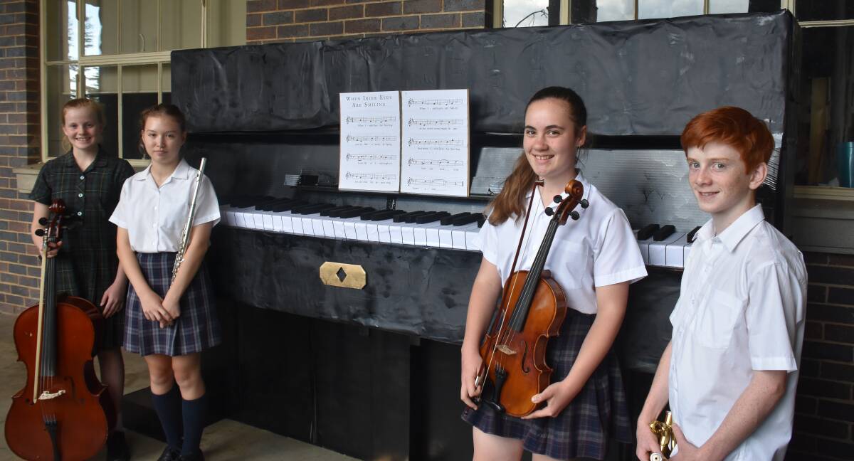 SOME OF THE PIANO BUILDERS: Madeleine George, 13, Presbyterian Ladies' College; Jessie Franklin and Juliet Knuckey, both 15, from Armidale High School; and Dylan Knox, 14, from Duval High School.  Photo: Nicholas Fuller.