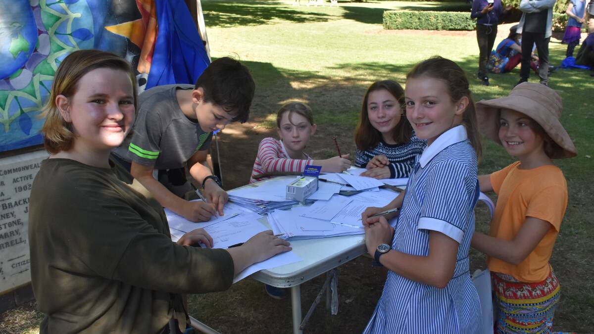 CAMPAIGN: Students writing letters to Prime Minister Scott Morrison - Stephanie Clarkson at left, and Arlie Bragg right, in orange. Photo: Nicholas Fuller