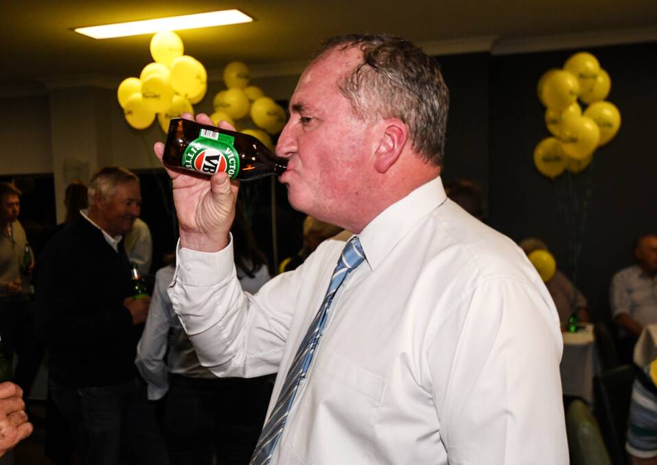 CHEERING: Barnaby Joyce enjoys a drink after declaring victory in New England for a third term. Photo: Gareth Gardner 180519GGD08